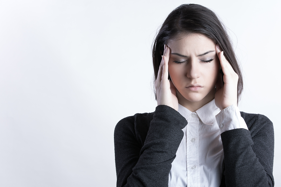 Young woman holding her head.