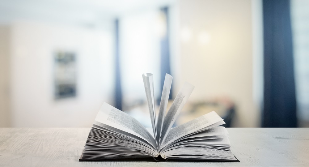 open book on white wooden table in the living room