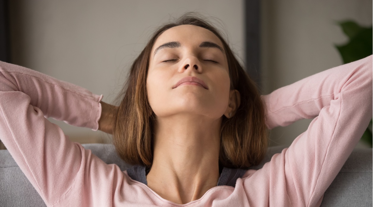 woman leaning back in chair closing her eyes. ilasik for pressure behind eyes