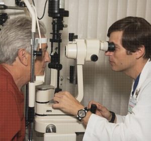 image of doctor checking patients eyes