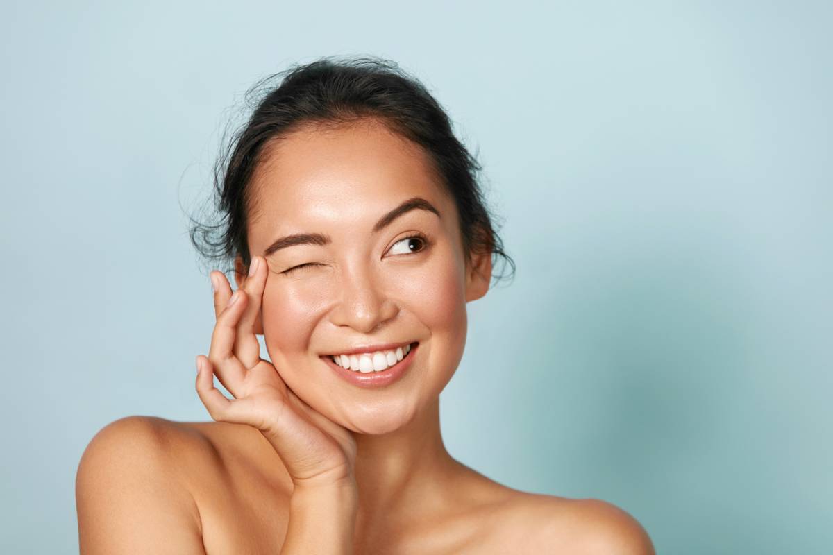 Woman winking after having learned about common eye myths.